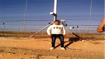Bilal_posing_for_a_picture_by_the_fence_in_the_buffer_zone